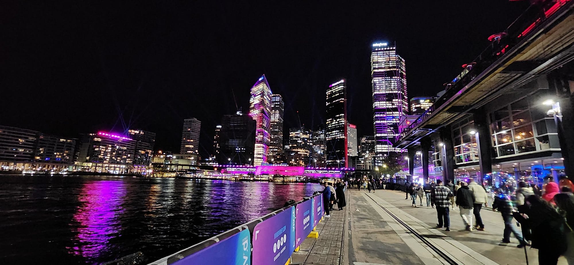 Crowds gather among illuminated installations at Vivid Sydney 2023.